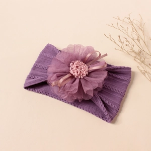 Close-up of purple knit baby headband with large mesh flower and delicate ribbon bow