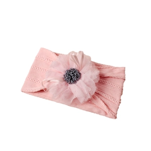 Pink jacquard nylon baby headband with a large mesh flower and delicate ribbon bow