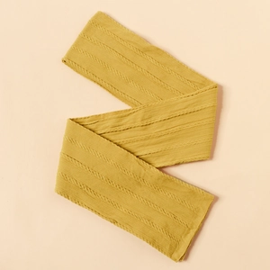 Detailed view of ginger yellow cable knit texture on a soft baby nylon headband