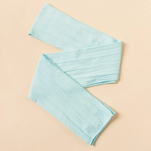 Detail of light blue nylon jacquard headband with intricate cable knit texture for infants