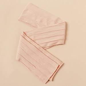 Detailed macro view of soft pink baby nylon headband with intricate cable knit texture