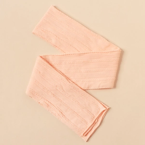 Close-up of soft light pink nylon jacquard baby headband with intricate knit pattern