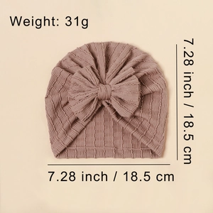 Dusty pink waffle knit baby turban hat with oversized bow and stretchy breathable fabric