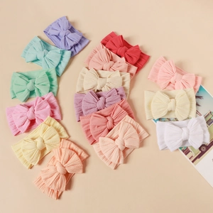 Close-up of 16-color nylon baby headbands set with large double-layered jacquard bows