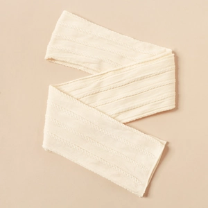 Close-up of cream white cable knit nylon fabric showing texture for baby headbands