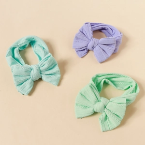 Three-piece set of knitted nylon bow headbands for babies in pastel colors with cable texture