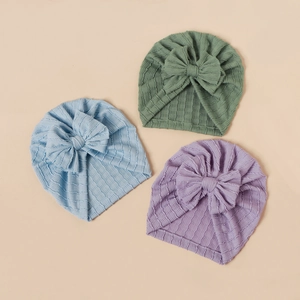 Three elastic baby turban hats with large bows in sage green, light blue, and lavender purple