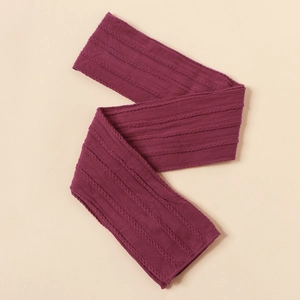 Detail view of burgundy jacquard knit nylon headband with textured cable pattern