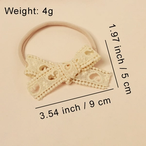 Detailed view of beige lace bow headband with heart patterns and dimensions
