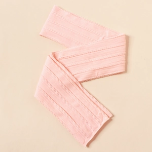 Close-up of pink cable-knit nylon baby headband fabric with detailed floral texture