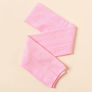 Close-up of pink nylon jacquard headband fabric featuring detailed cable knit patterns