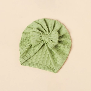Close-up of light green jacquard baby turban hat with a large decorative bow