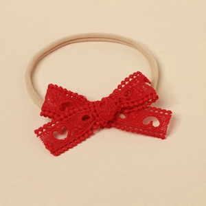 Detailed view of baby headband with red lace bow featuring heart cutouts and elastic nylon