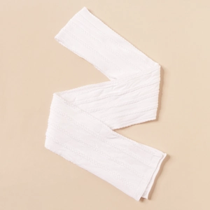 Detail showing the intricate white cable knit pattern and elastic texture of the fabric