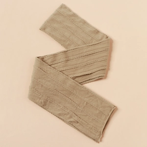 Detailed macro view of beige cable-knit pattern on soft jacquard nylon baby headband