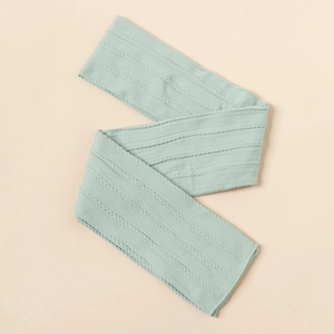 Detail of mint green baby nylon headband showing soft jacquard knit texture and elasticity