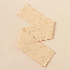 Detail of beige nylon jacquard baby headband showing soft cable knit texture and elasticity