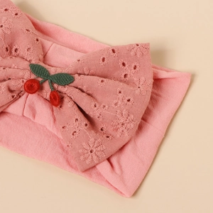 Pink newborn nylon headband with large floral cutout bow and cherry embroidery