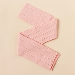 Detail of pink cable knit nylon fabric showing texture and elasticity for baby headbands