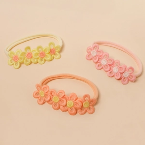 Three-piece set of nylon baby headbands featuring soft embroidered flowers in warm tones