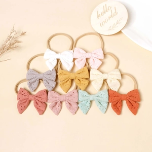 9-piece set of nylon baby headbands with embroidered eyelet fabric bows in candy colors