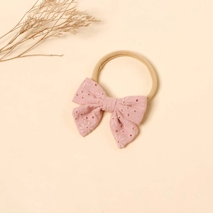 Detail of pink embroidered butterfly bow baby headband with soft nylon elastic band