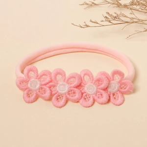 Detail of pink nylon baby headband with five delicate embroidered lace flowers