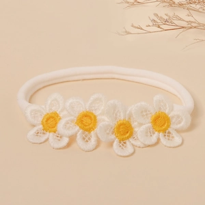 Close-up of soft nylon baby headband with delicate embroidered white daisy flowers