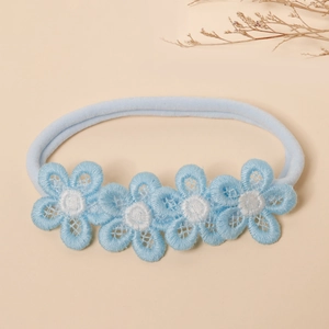 Detailed view of light blue baby headband with five embroidered lace flowers and nylon strap