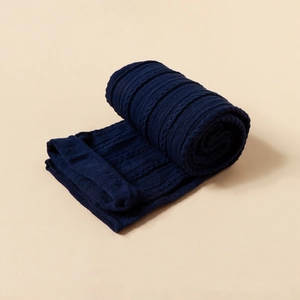 Detailed view of dark blue cable knit fabric texture on newborn elastic headbands
