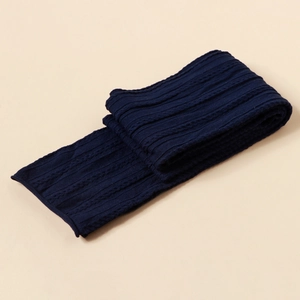 Detailed view of dark blue cable-knit baby headband with thick textured knit patterns