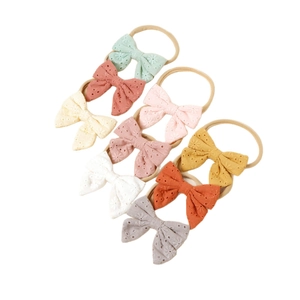 10-piece set of baby nylon headbands with delicate eyelet lace bows in assorted candy colors
