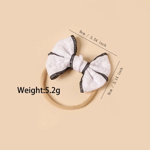 Elastic nylon baby headband with white lace jacquard bow and black stitched edges