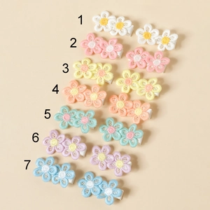 Close-up of embroidered lace flower hair clips for kids showing colorful floral textures