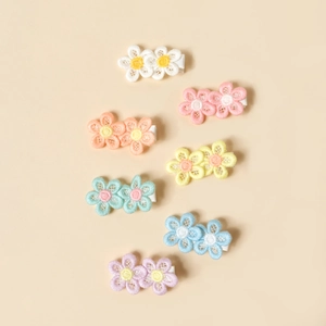 Detail of embroidered lace flower hair clips for kids in seven pastel macaron colors