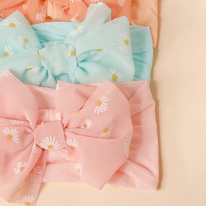 Three-pack of baby nylon headbands with daisy print and large bows in soft pastel colors