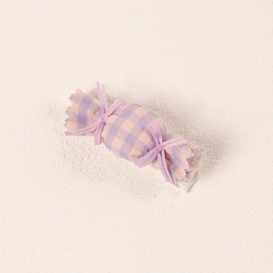 Detail of baby candy-shaped hair clip with pink and purple checkered fabric and ribbon