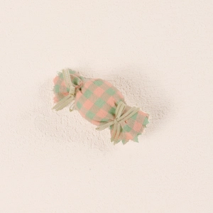 Close-up of pink and green plaid candy-shaped fabric hair clip for babies and girls