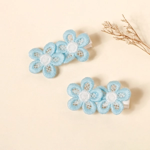 Detail of blue daisy embroidered lace hair clips with fabric wrapped metal base for kids