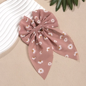 Detailansicht der Morandi rosa Schleife Haarklammer mit Gänseblümchen und langen Bändern