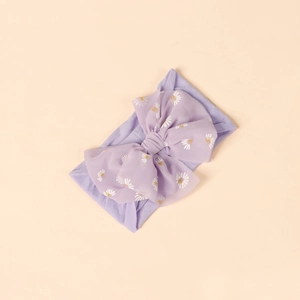 Detail of lavender baby headband with soft nylon fabric and large floral daisy bow