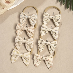 Detailed set of eight floral pattern baby headbands with elastic nylon and cotton bows