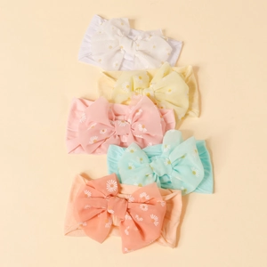 5-pack soft nylon baby headbands with oversized daisy print bows in pastel candy colors