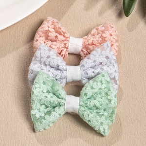 Detailed embroidery on lace bow hair clips in pink white and green pastel colors
