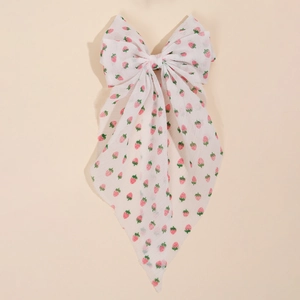 Detailed shot of floral strawberry print bow hairclip with long chiffon streamers