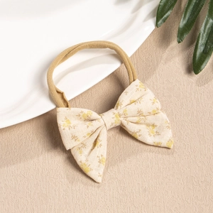 Detail of baby headband featuring floral fabric bow and stretchy nylon strap