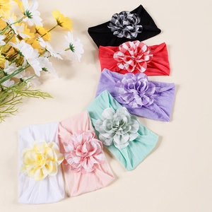 Detail of six colorful elastic baby headbands with large checkered fabric flowers
