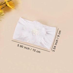 Detail showing white baby headband with mesh silk flower and elastic fabric sizing