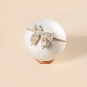 Bandeau élastique en nylon avec nœud en coton brodé de marguerites pour bébé fille