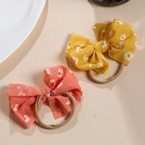 Baby-Stirnbänder mit floralen Schleifen, gelbe und orangefarbene Gänseblümchen-Prints